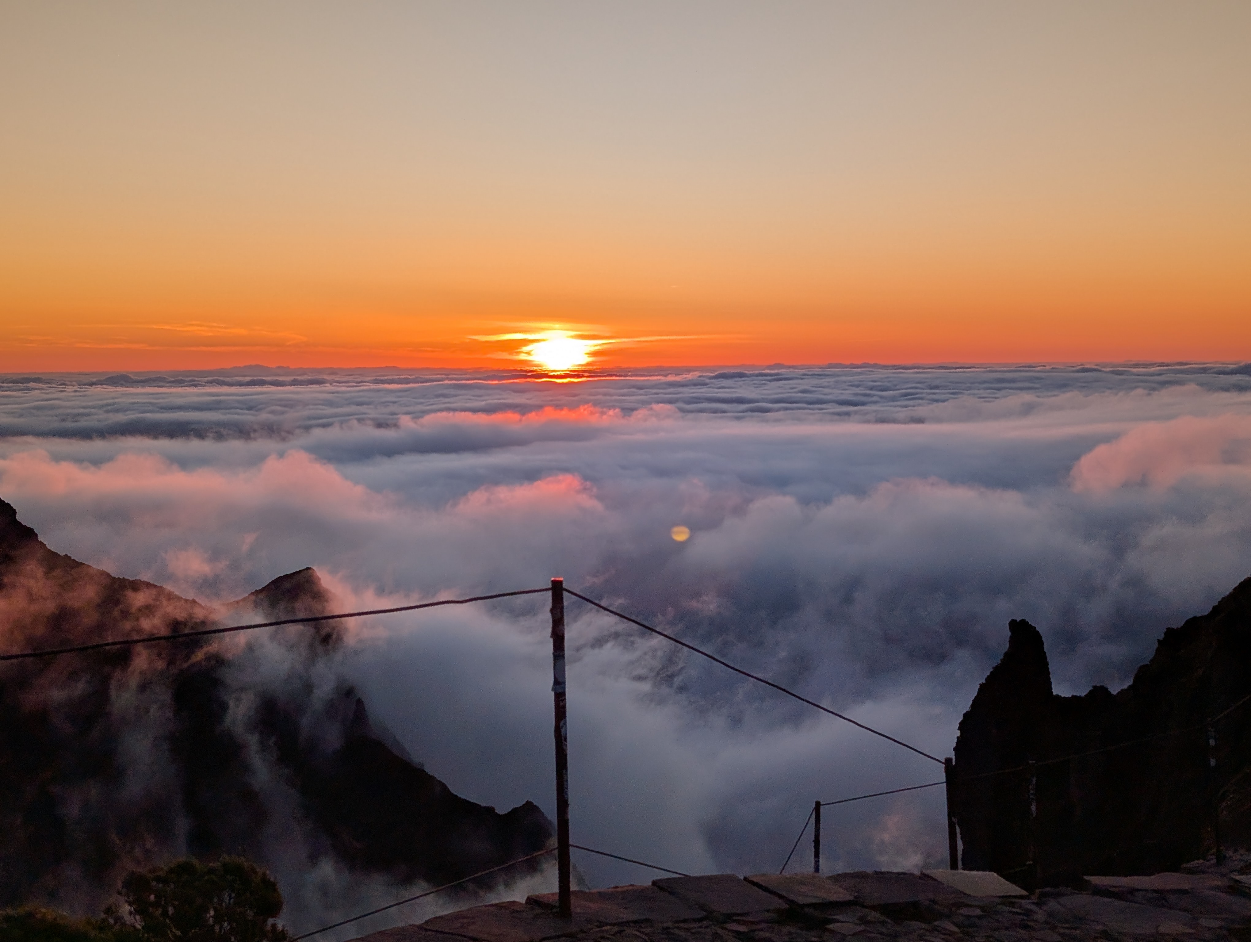 The sun setting over a sea of clouds in Madeira